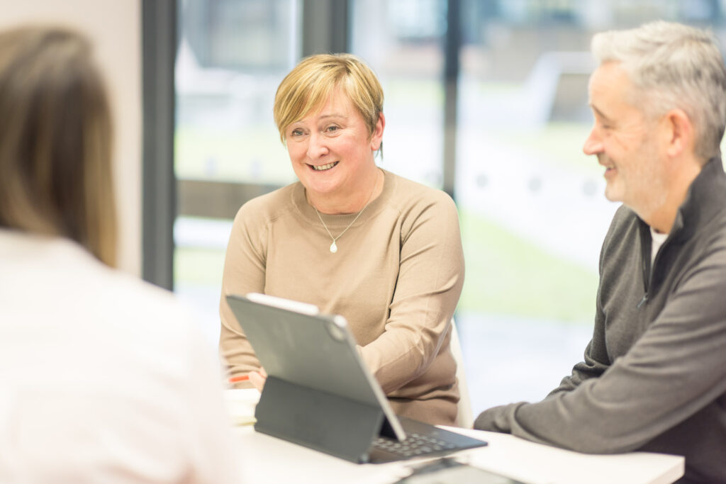 Darren Stott and Jane Reynard talking in a meeting